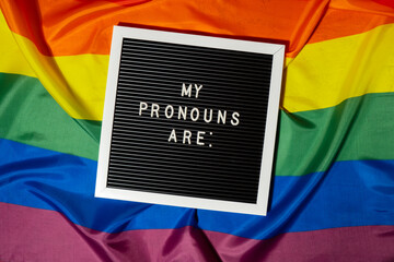 MY PRONOUNS ARE text Neo pronouns concept on Rainbow flag background gender pronouns. Non-binary...