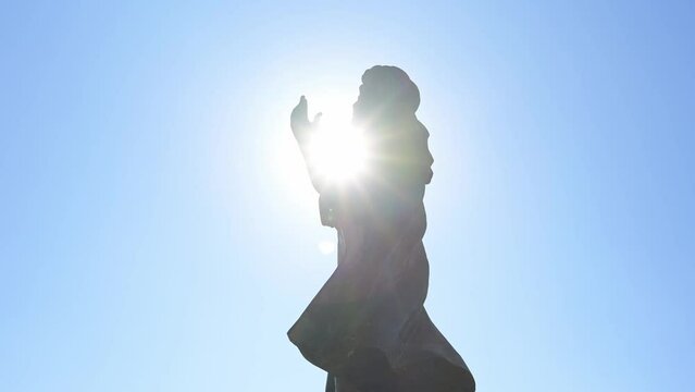 Silhouette of Al-Mutanabbi statue with blinding sun behind, Baghdad in Iraq. Low angle and space for copy
