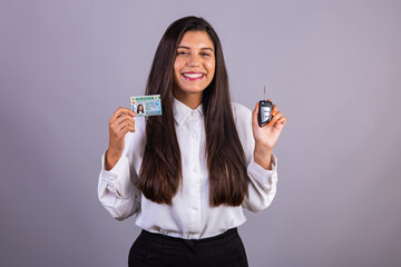 Brazilian businesswoman with driver's license and car key. Translation in English (national driver's license) - obrazy, fototapety, plakaty