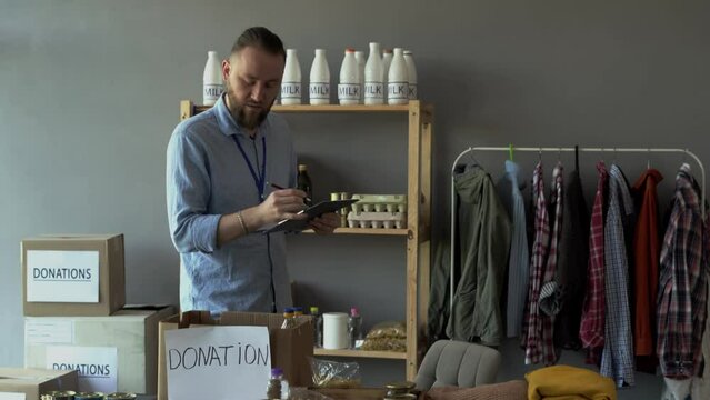Social worker. People working on humanitarian aid project. Man in homeless shelter. Volunteers are working