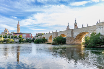 Fototapeta na wymiar Zaragoza, Spain - May 01, 2023: medieval bridge called Puente de Piedra that crosses the Ebro river as it passes through the city of Zaragoza, Spain