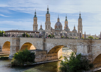 Zaragoza, Spain - May 01, 2023: medieval bridge called Puente de Piedra that crosses the Ebro river...