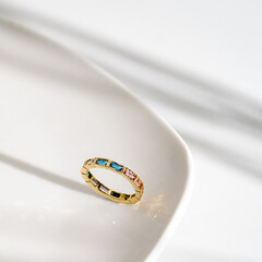 Horizontal baguette multi coloured precious stone eternity ring.