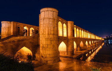 Si-o-Se Pol (Bridge of 33 Arches or Allahverdi Khan Bridge) at night on Zayanderud River in...