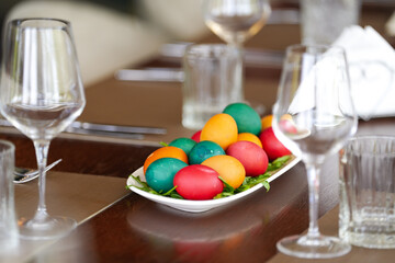 Easter concept photo. A lot of eggs painted in multiple color on a wooden table for the Easter food lunch.