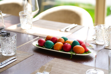 Easter concept photo. A lot of eggs painted in multiple color on a wooden table for the Easter food lunch.