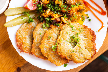 belarusian draniki with grilled beef dish in a restaurant