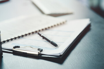 Pen, paper and form or document for information, contract or life insurance application on a table....