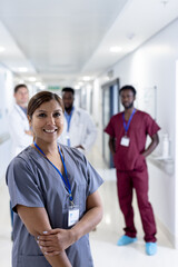 Unaltered portrait of asian female doctor doctor smiling in corridor, copy space