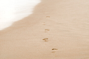 Foot print on sand at the beach. Beautiful sandy tropical beach, footsteps on the shore.
