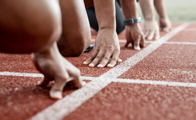 Ground, hands and people ready for a race, running competition or training at a stadium. Fitness, sports and athlete runners in a line to start a sprint, exercise or challenge in track or athletics - obrazy, fototapety, plakaty