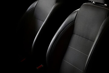 Car seats on a black background. Car seat backrests with lateral support. - obrazy, fototapety, plakaty