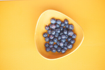 fresh blue berry in a orange color bowl 