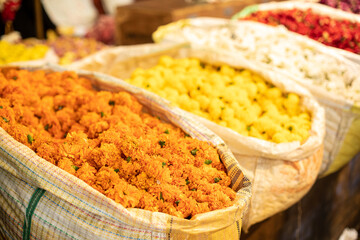 Colorful dried chrysanthemum flowers at Goa market in India. Desiccated orange, yellow, white and red blossom sold.