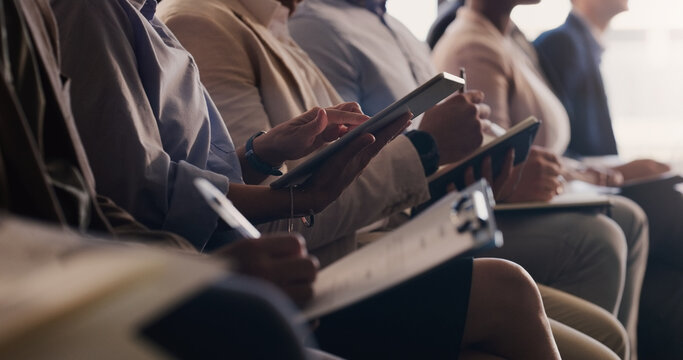 Audience, conference and business people with a tablet and notes at a seminar, workshop or training. Hands of men and women crowd at a presentation for learning, knowledge and writing information