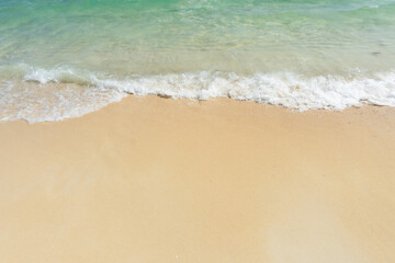 Fototapeta na wymiar Soft wave of sea on empty sandy beach Background with copy space..