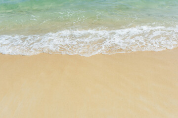 Obraz na płótnie Canvas Soft wave of sea on empty sandy beach Background with copy space..
