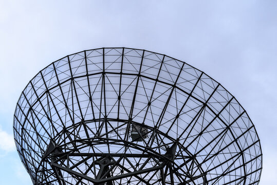 Close up of a radio satellite against a blue sky