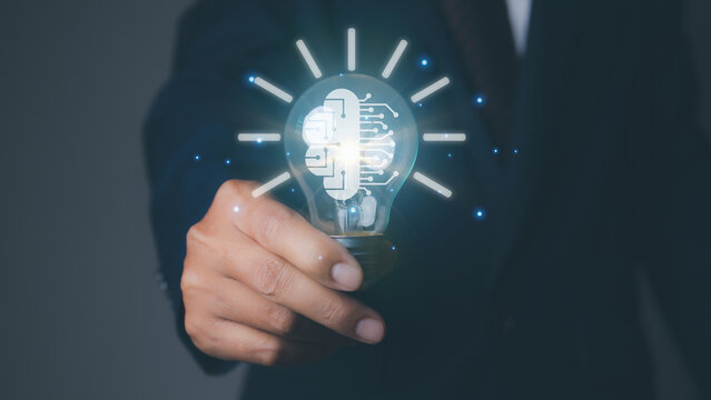 Businessman holding light bulb with brain icon of Brainstorming creative idea.