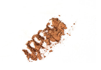 Top view of brown nude eyeshadow swatch on isolated background. Crashed smear with shimmer powder texture. Smokey make up