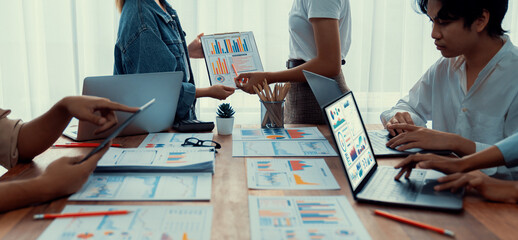 Panorama shot analyst team utilizing BI Fintech to analyze financial report with laptop....