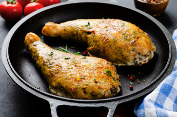 Baked Stuffed Chicken Legs in a Pan on Dark Backround