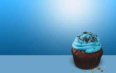 Sweet tasty cupcake with sprinkles and candle