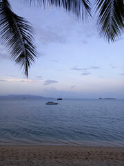 Tropical beach at sunset in beautiful pastel lavendel colors as background, Koh Samui, Thailand.