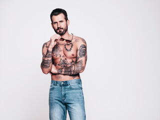 Portrait of handsome confident stylish hipster lambersexual model in jeans. Sexy modern man. Naked...