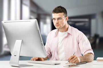 Mature businessman doing paperwork in office