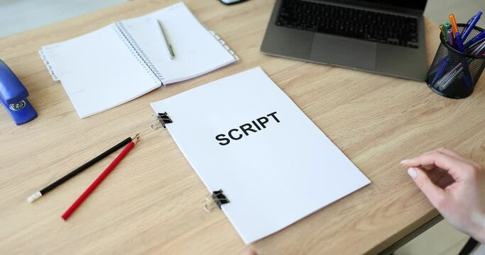Screenwriter holds folder of documents labeled script. Development of plots for films and series concept
