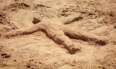 A man made of sand on the beach