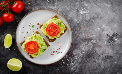 Avocado Toasts with Tomato, Healthy Snack or Breakfast on Dark Background