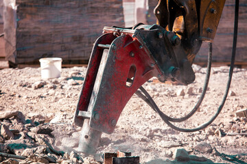 Jackhammer machine breaks concrete in the city.