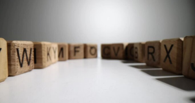 Wooden cubes with letters of English alphabet on table. Alphabet designed for children's games and skill development