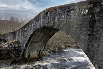 Historic stone bridge at Loch Ranghoch, river tummel, Scotland.