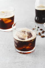Iced Coffee, Sparkling or Cold Brew Coffee with Ice on Bright Background, Coffee Cocktail, Refreshing Beverage