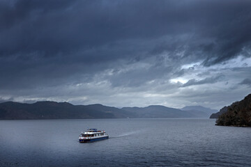 Loch Ness. Urquhart Castle. Lake. Scotland. Fog. Misty morning. Tourboat.