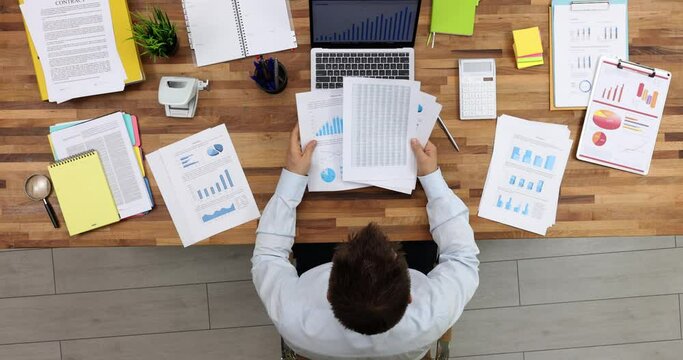 ata analysis and business statistics concept seo businessman studying documents top view. Management analyzes infographic statistical graphs of work results and charts