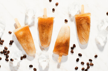 Coffee Popsicles, Refreshing Ice Lollies with Coffee Beans and Ice on Bright Background