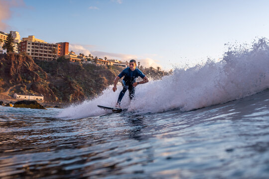 Side view of man surfing on sea at sunset