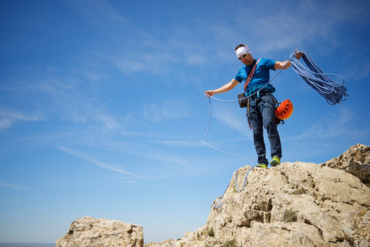 Climber picking up the rope at the summit of Palomera Peak.