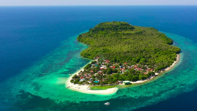 White sand beach and boats. Tropical island for tourists, top view. Himokilan Island, Leyte, Philippines. Summer and travel vacation concept.