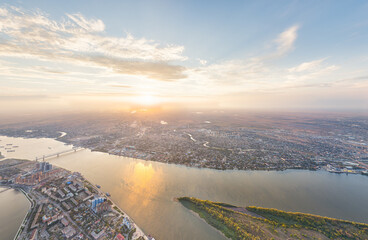 Astrakhan, Russia. Panorama of the city from the air in summer. The Volga River and Gorodstoy Island. Sunset time. Aerial view