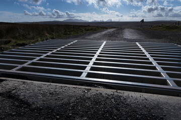 Cattle grid. Dirt road.  Landscapes near Thurso Nothern Scotland.