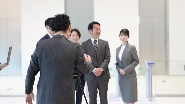 Video of photographers and employees shooting corporate images in the lobby of a company