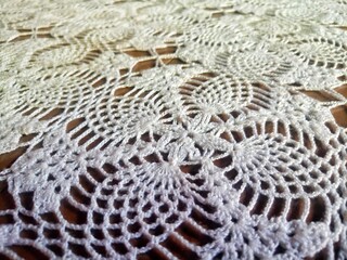 Crochet Patterns made of white thread. Wallpaper and white background.