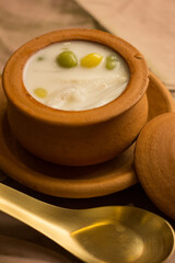 antique bowl of Thai sweet 
dessert with golden spoon