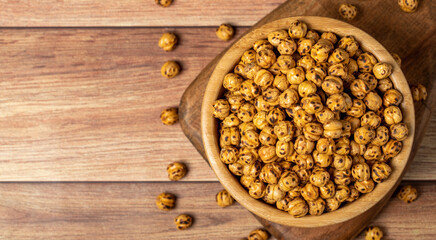 Roasted chickpea. Roasted chickpeas in wooden bowl. superfood Vegetarian food concept. healthy snacks. Top view. Copy space. Empty space for text