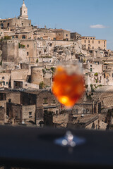 MATERA / ITALY - MAY 2023: Enjoying an Aperl Spritz with a wonderful view over the ancient town.